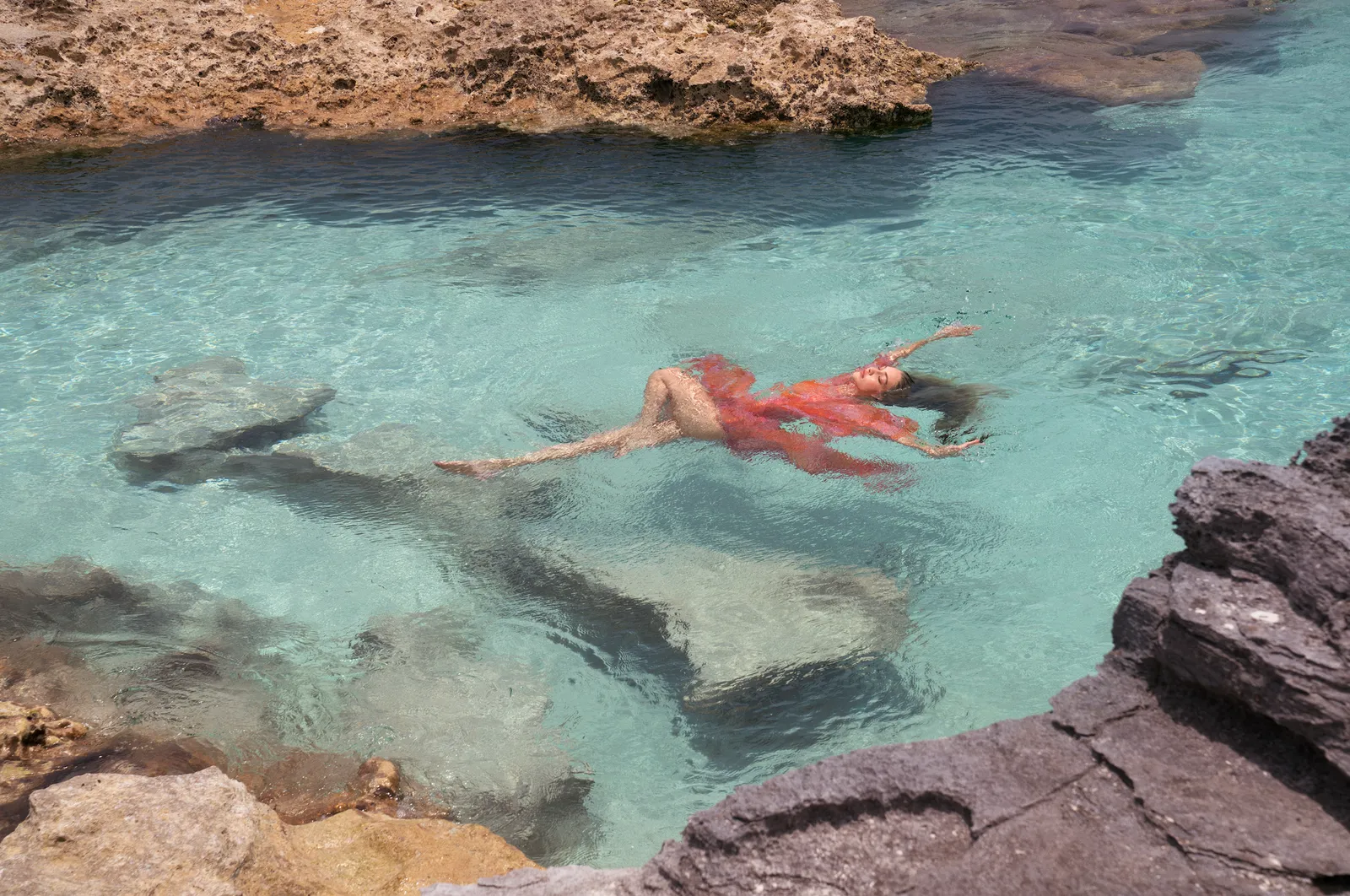 Michael Kors Wonderlust campaign image in turquoise water